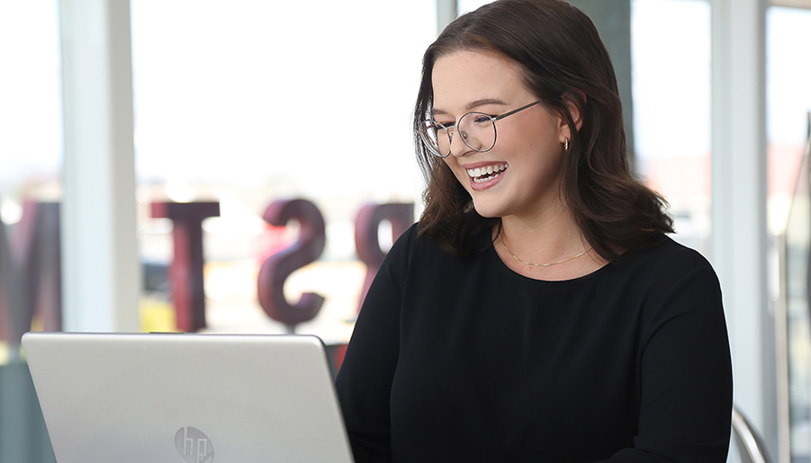 woman smiling at laptop